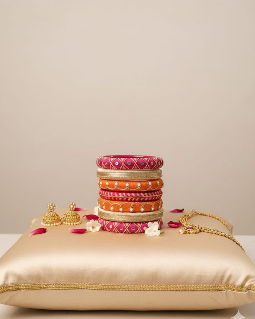 Stack of colorful bangles on a gold pillow with a beige background